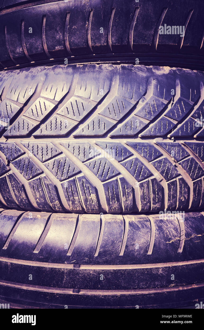 Vintage toned close up picture of used car tires. Stock Photo