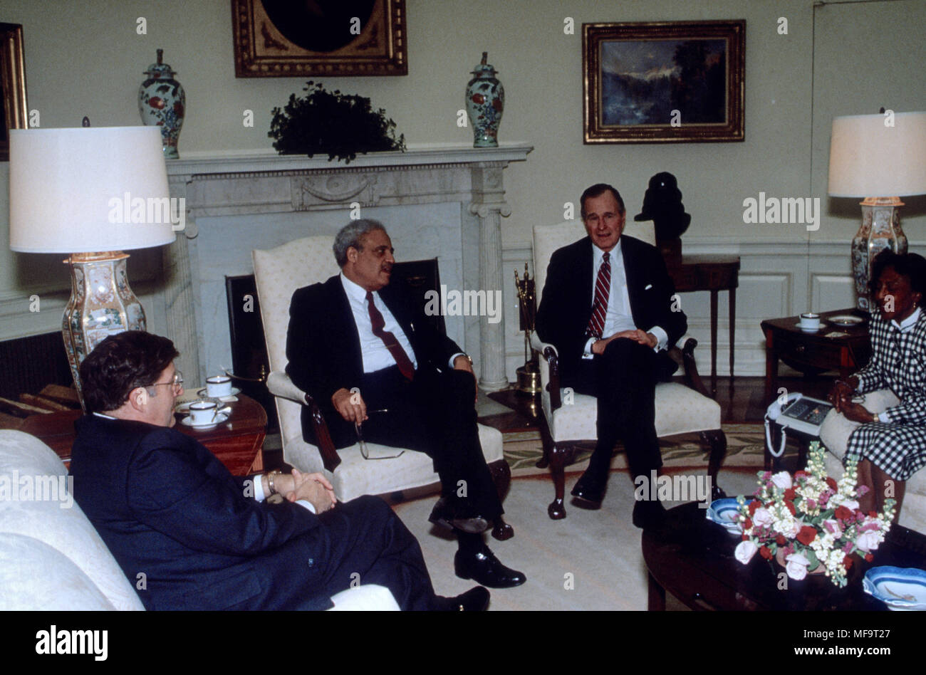 President George H.W. Bush sits in the Oval Office with Reverend Doctor Benjamin Hooks the director of the NAACP and his wife Francis Credit: Mark Reinstein/MediaPunch Stock Photo