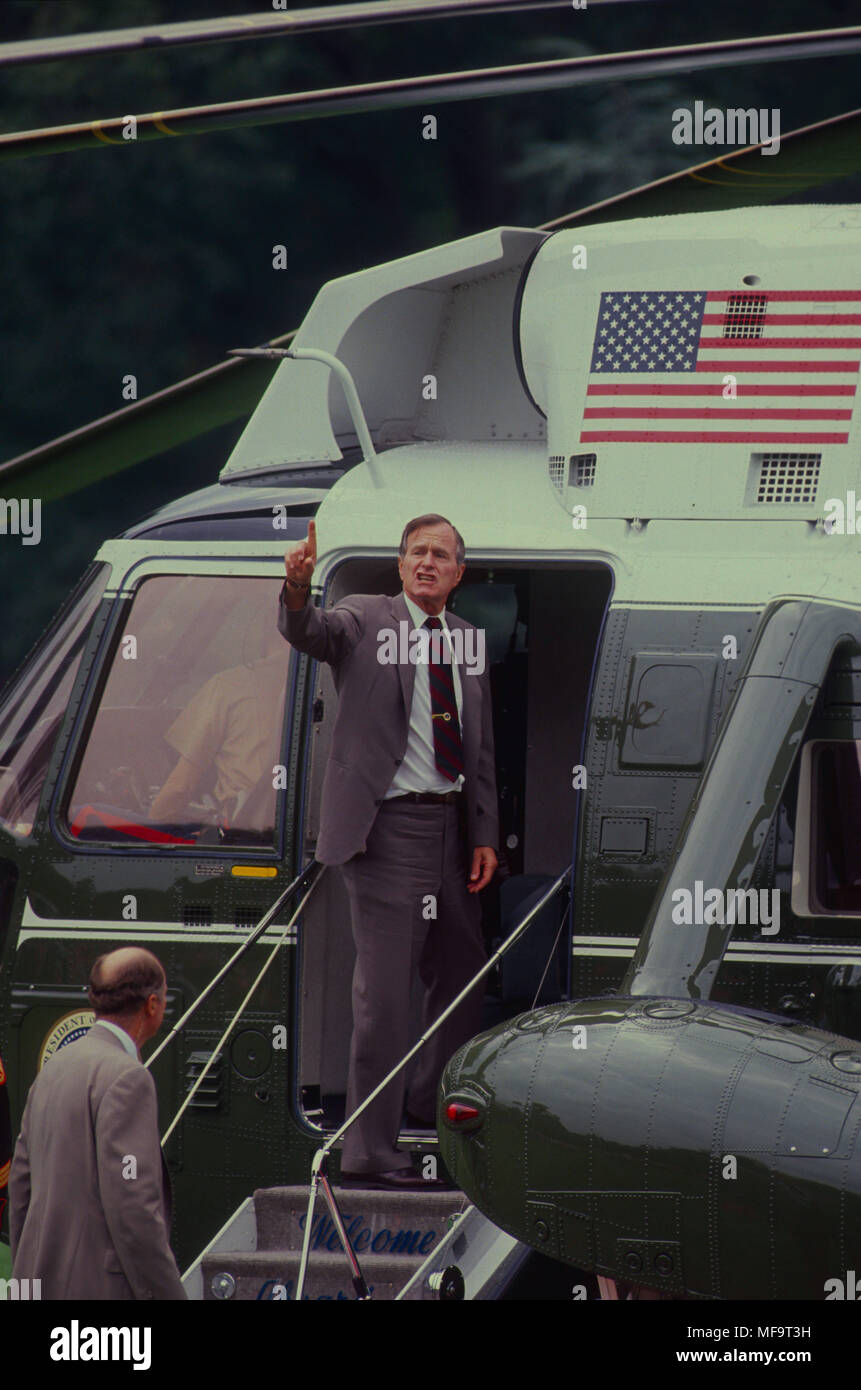President George H.W. Bush waves from the steps of Marine One before ...