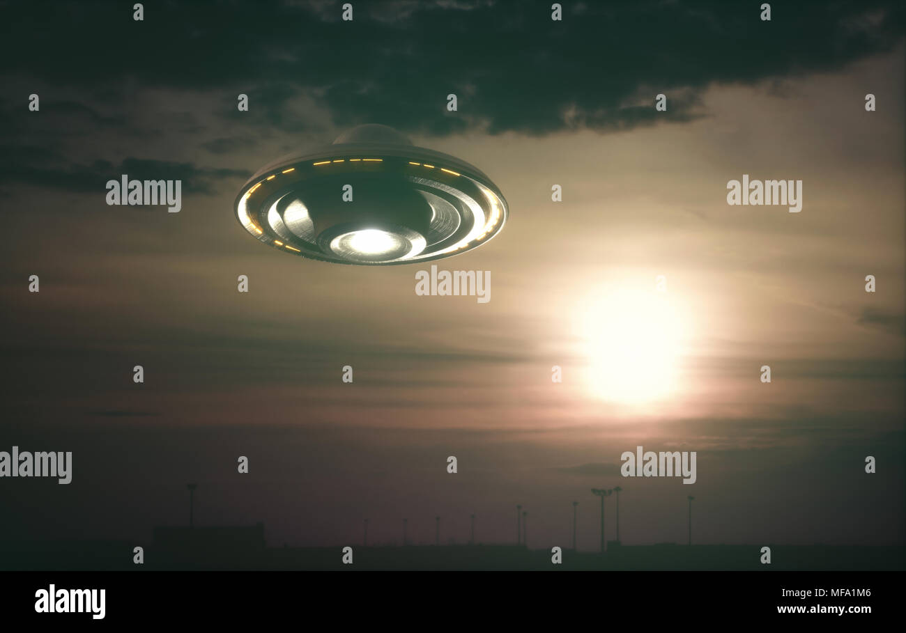 Unidentified flying object, UFO with the sunset in the background. Stock Photo