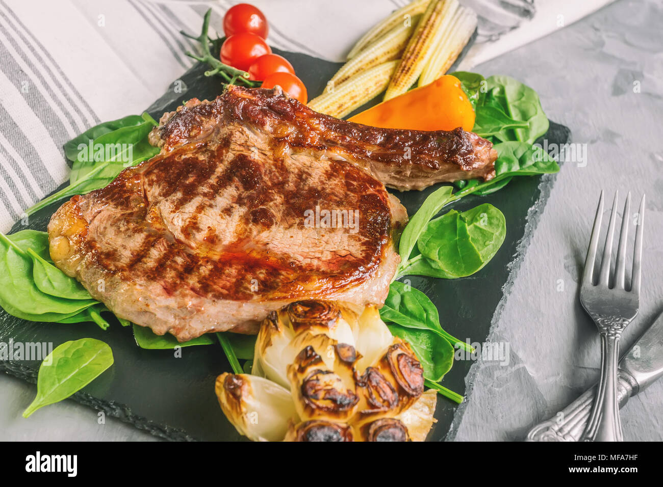 Rare steak with blood pepper garlic tomatoes broccoli grilled on a ...