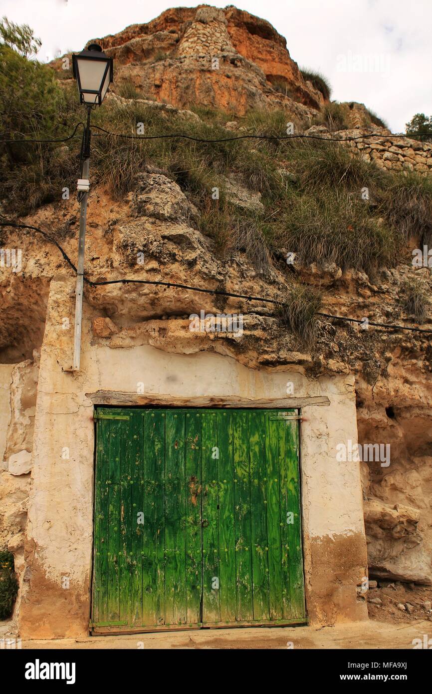 Old Garage With Green Wooden Door Excavated In The Mountain In