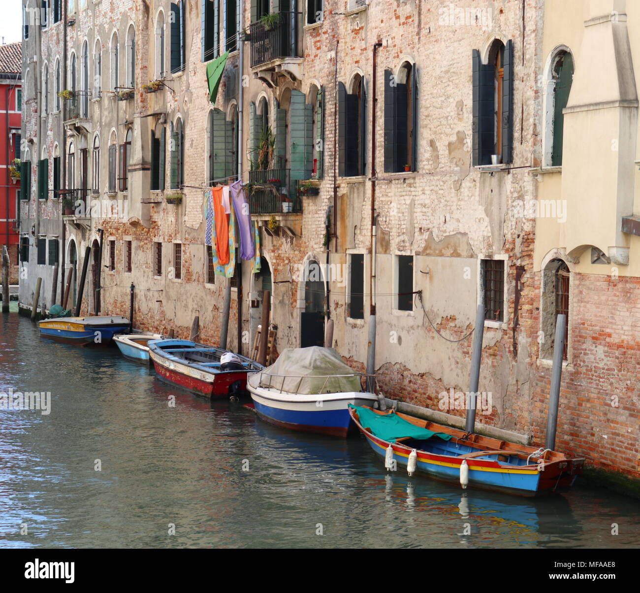 Picturesque scenery, colourful boats, old facade with shutters, canal, Venice, Italy, Europe Stock Photo