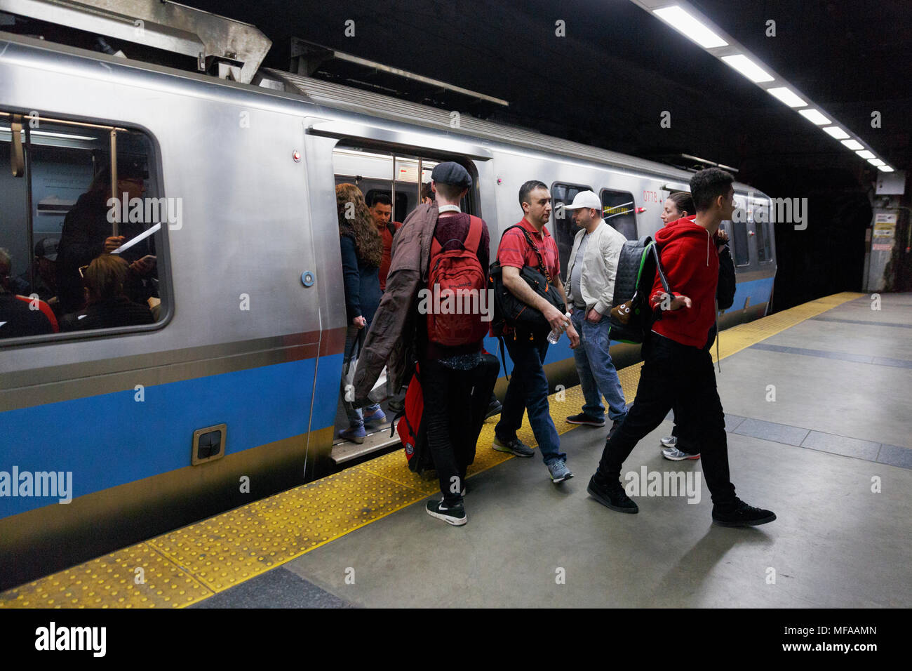 People passengers leaving boarding a subway train on the Blue Line, Maverick Station, Boston Massachusetts USA Stock Photo