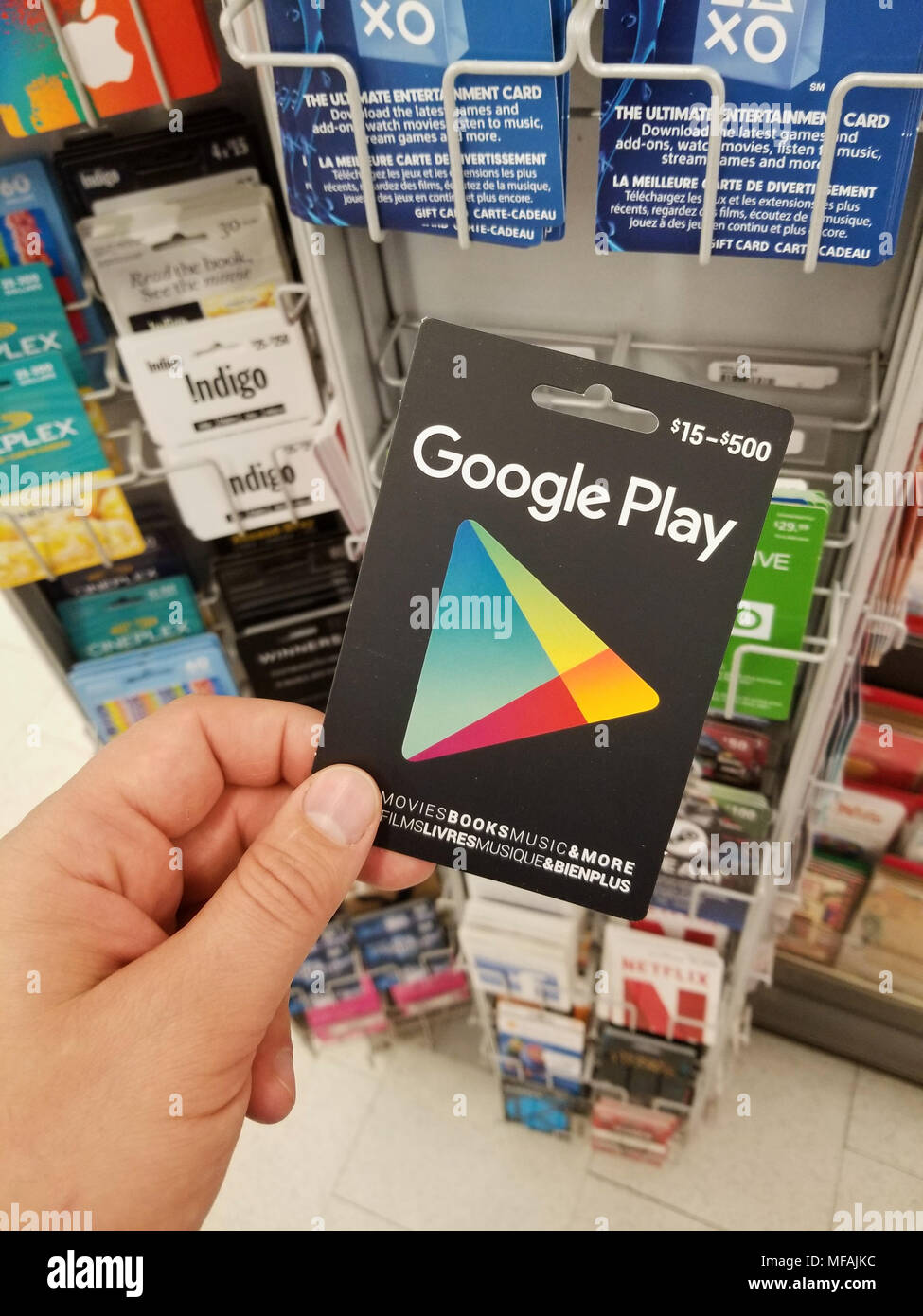 MONTREAL, CANADA - NOVEMBER 7, 2017: A hand holding a Google Play gift card. Google Play previously Android Market is a digital distribution service o Stock Photo