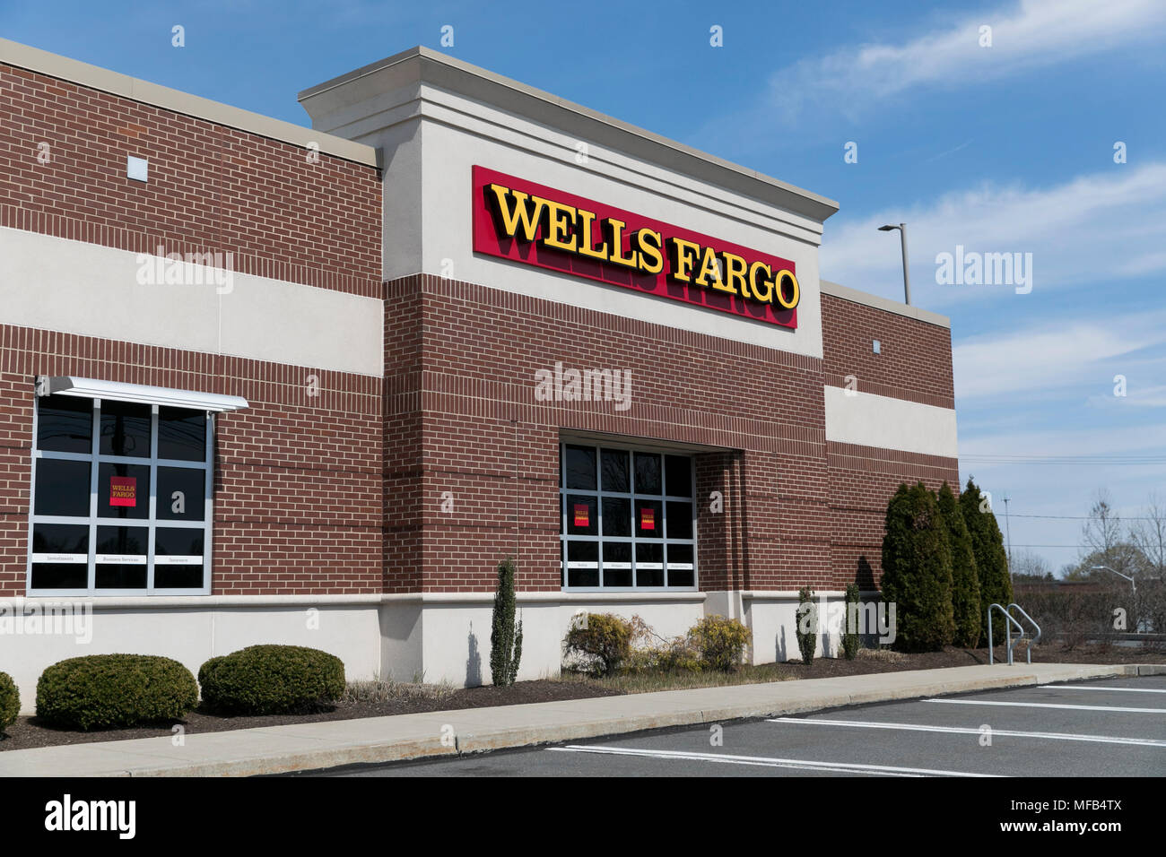 A logo sign outside of a Wells Fargo bank branch in Reading, Pennsylvania, on April 22, 2018. Stock Photo