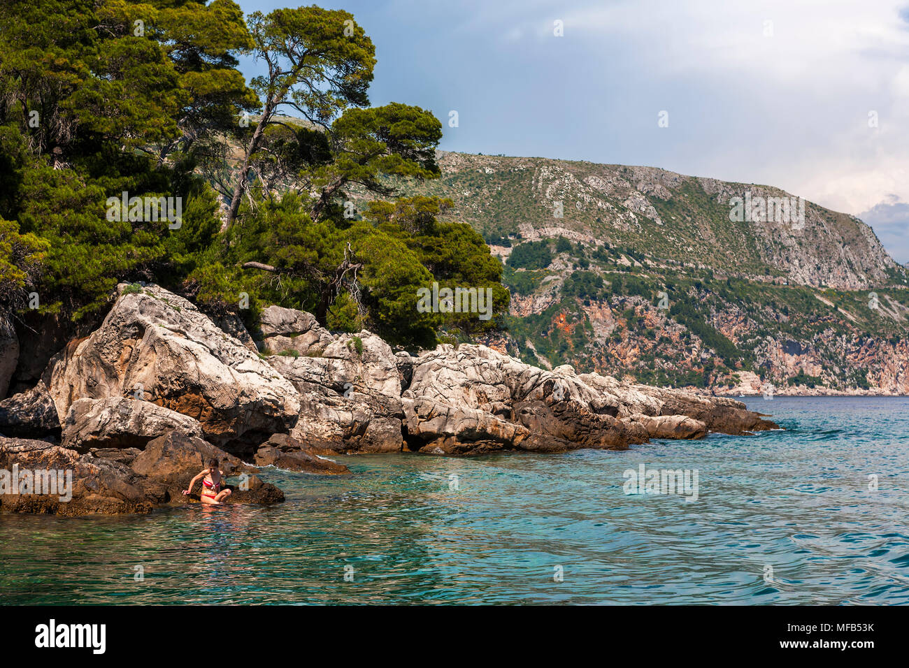 Bathing With Rocks Girl bathing from rocks, Otok Lokrum, Croatia Stock Photo - Alamy