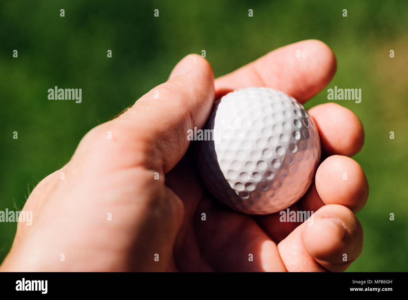 Golfer holding golf ball, close up of male hand Stock Photo Alamy