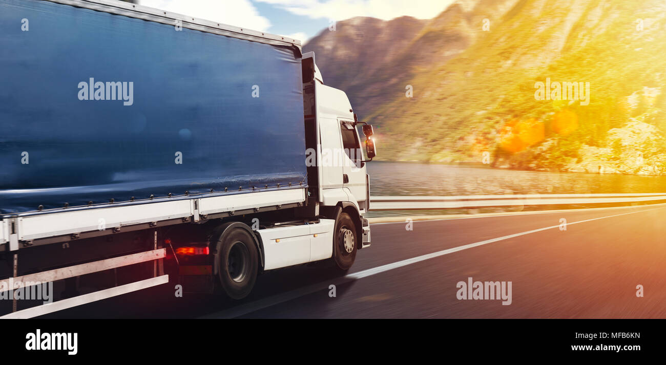 Truck run fast on the highway to deliver Stock Photo