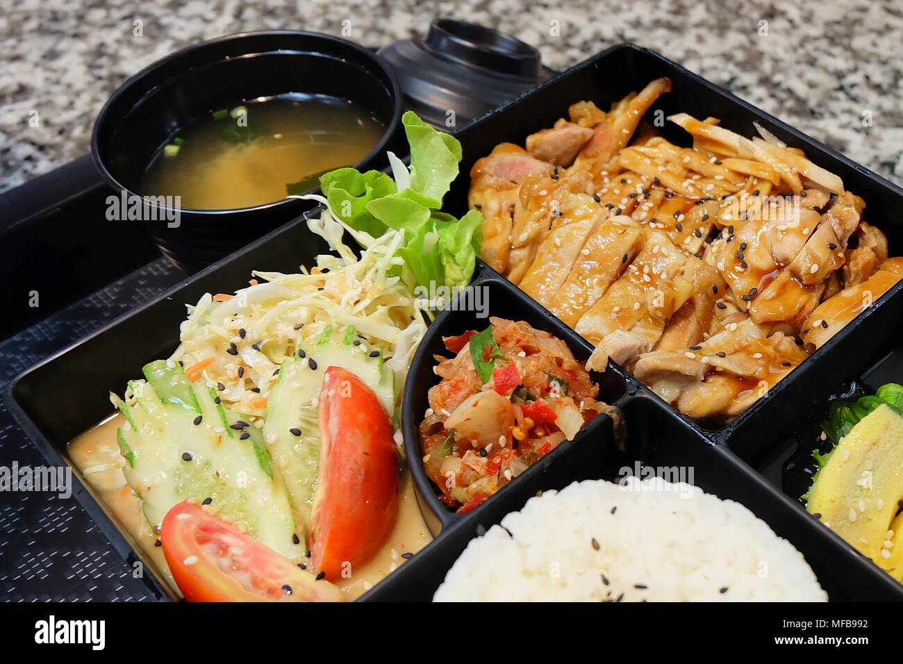 https://c8.alamy.com/comp/MFB992/traditional-japan-cuisine-bento-box-or-multi-layered-box-with-teriyaki-chicken-rice-salad-tamagoyaki-or-rolled-omelette-hiyashi-wakame-or-seaweed-MFB992.jpg