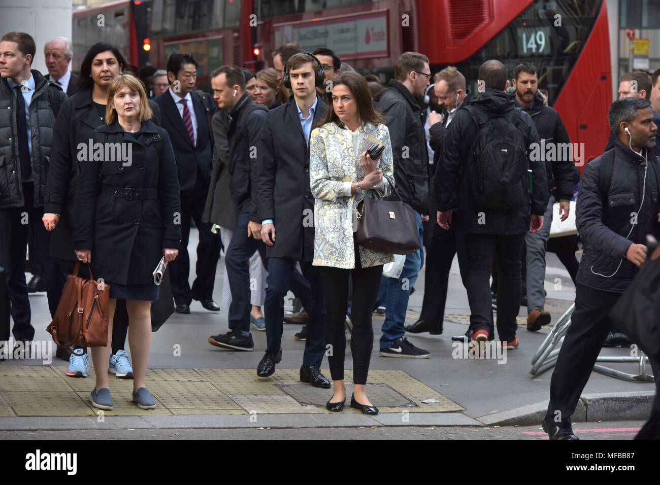 Office workers commuting to work during the morning rush hour in the City of London Stock Photo