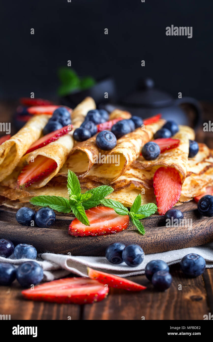 Healthy vegan pancakes crepe with blueberry and strawberry Stock Photo