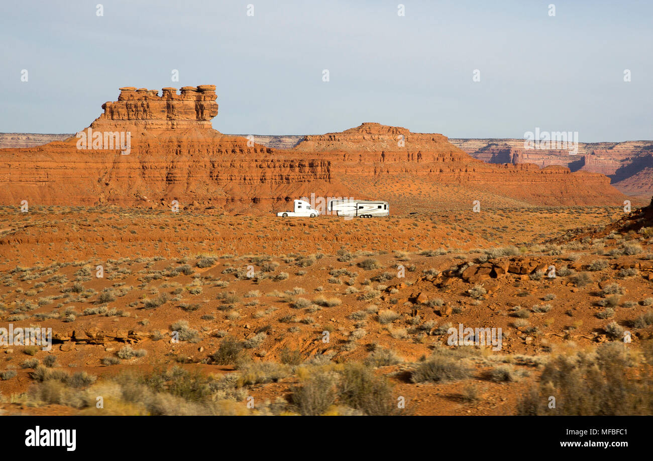 A white semi tractor truck and trailer camper recreational vehicle RV camping in the desert landscape of southern Utah, southwestern United States Stock Photo