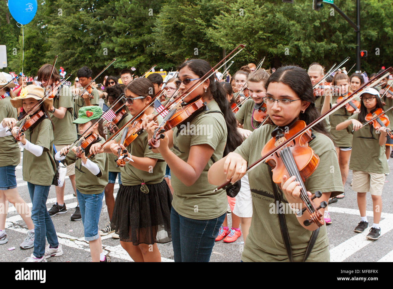 A youth violin group called the Fulton County Fiddlers plays while walking in the annual Old Soldiers Day Parade on August 1, 2015 in Alpharetta, GA. Stock Photo