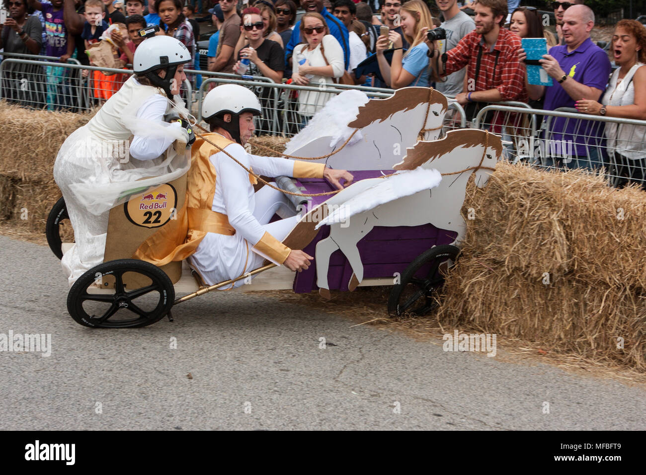 Competitors racing a vehicle designed like a Roman chariot crash