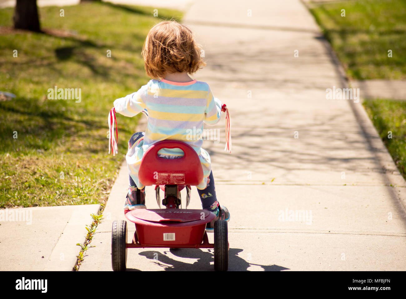 Girl Riding Tricycle Stock Photos & Girl Riding Tricycle Stock Images