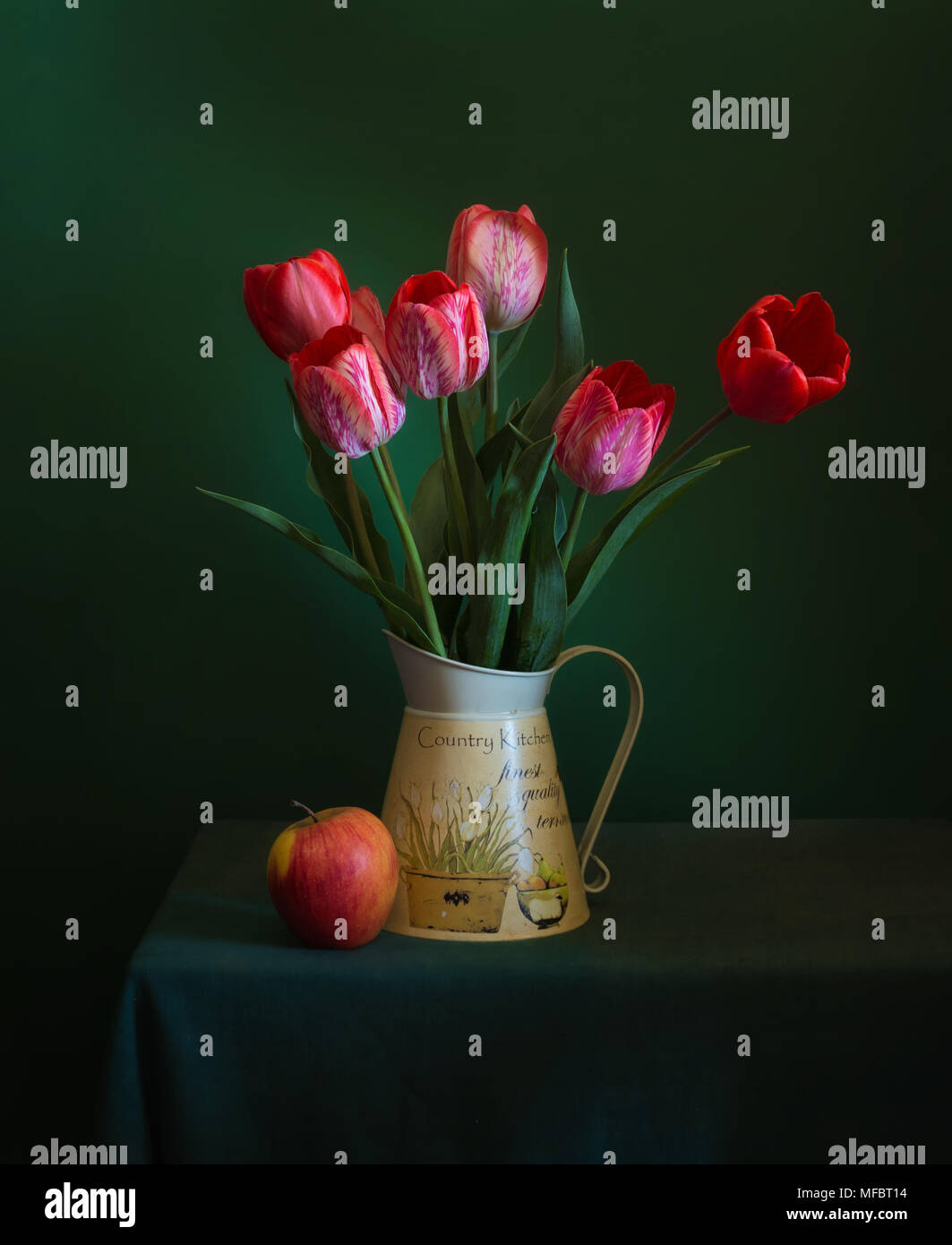 still life with a bouquet of tulips and an apple. vintage Stock Photo ...