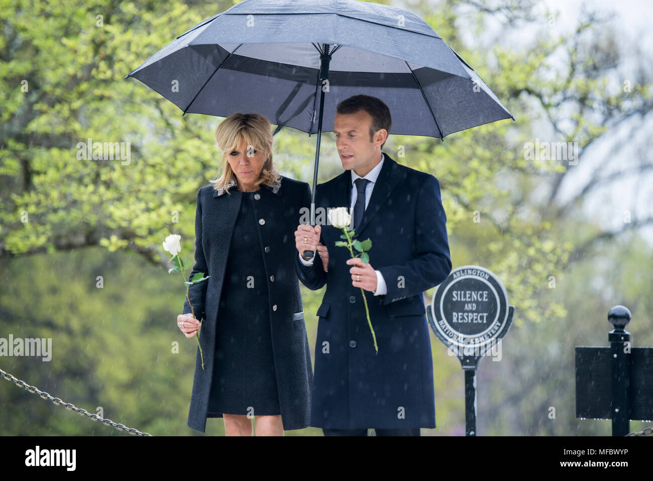 French President Emmanuel Macron and his wife, Brigitte Macron, lay roses on the gravesites of former President John F. Kennedy and Jacqueline Bouvier Kennedy Onassis at Arlington National Cemetery, Arlington, Virginia, April 24, 2018.  President Macron’s visit to Arlington National Cemetery was part of the first official State Visit from France since President Francois Hollande came to Washington in 2014. President Macron also laid a wreath at the Tomb of the Unknown Soldier as part of his visit. (U.S. Army photo by Elizabeth Fraser / Arlington National Cemetery / released) Stock Photo