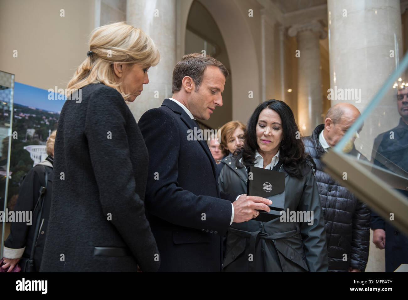 French President Emmanuel Macron (center) with his wife, Brigitte Macron (left), presents a gift to Karen Durham-Aguilera (right), executive director, Army National Military Cemeteries, in the Memorial Amphitheater Display Room at Arlington National Cemetery, Arlington, Virginia, April 24, 2018.  President Macron’s visit to Arlington National Cemetery was part of the first official State Visit from France since President Francois Hollande came to Washington in 2014. The French President along with his wife also visited the gravesite of former President John F. Kennedy. (U.S. Army photo by Eliz Stock Photo