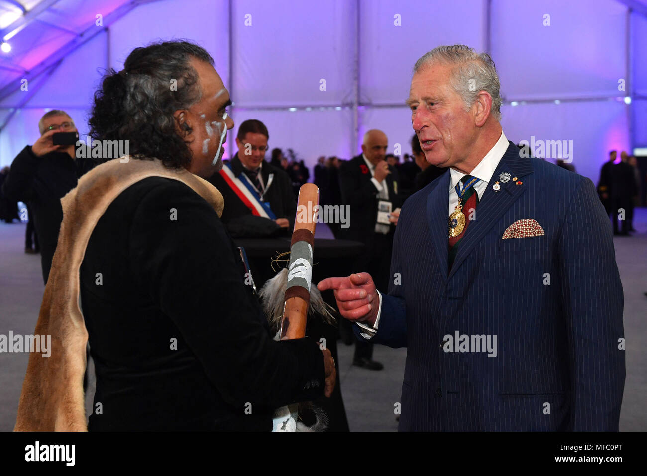 The Prince of Wales meets indigenous didgeridoo player David Dahwurr Hudson after an early morning memorial at the Villers-Bretonneux Memorial in France, to mark the 100th anniversary of the Battle of Villers-Bretonneux. Stock Photo