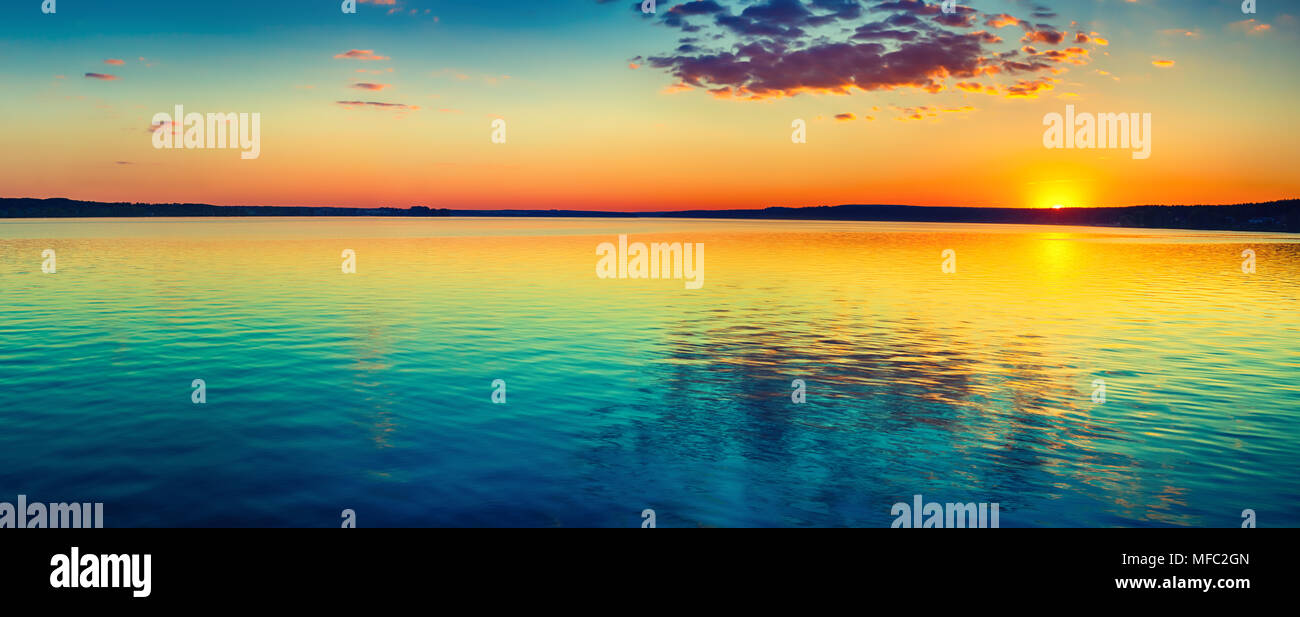 Sunset over the lake in Russia. Amazing landscape panorama Stock Photo