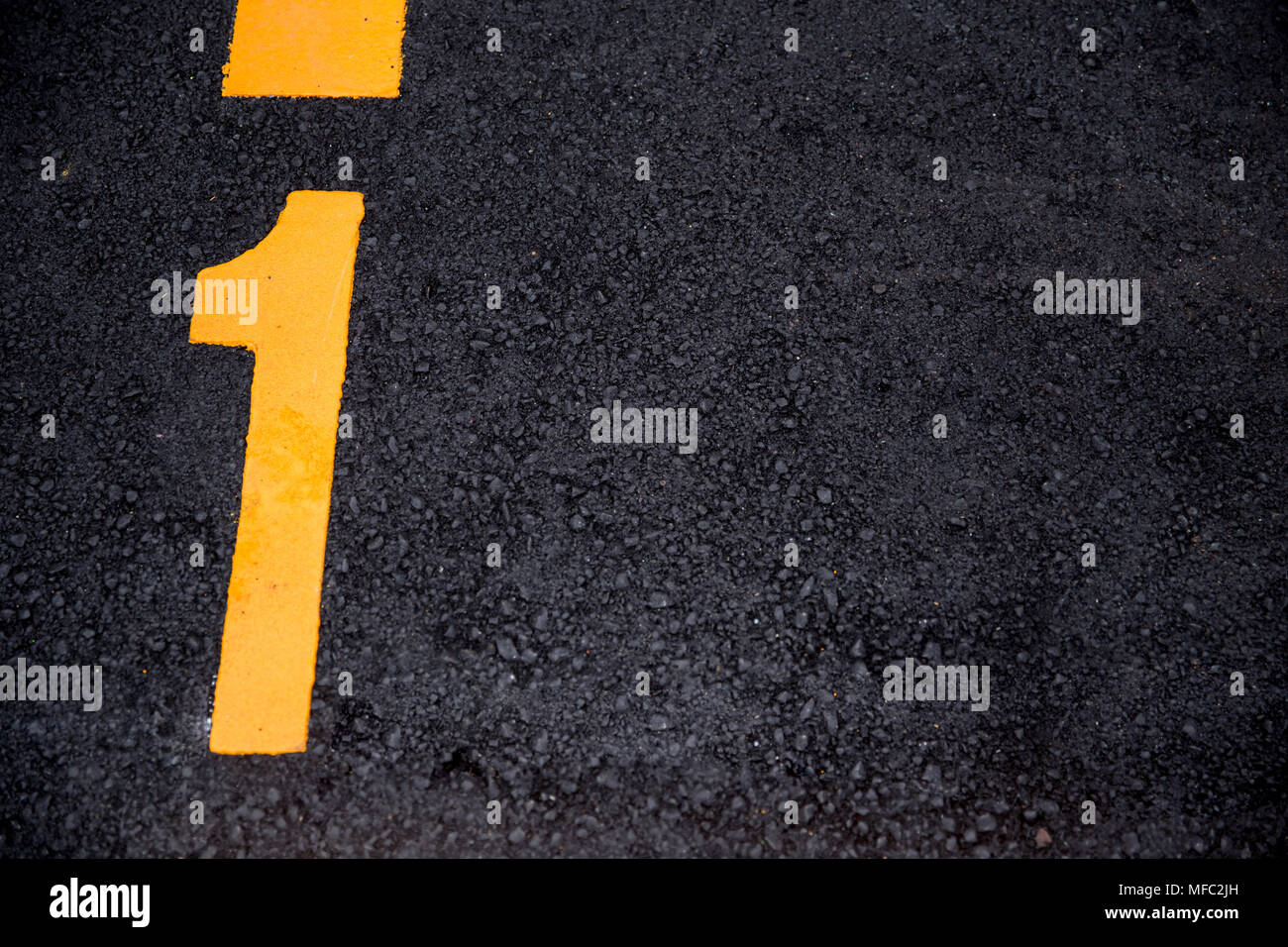 number 1 position paint on asphalt road background with copyspace Stock Photo