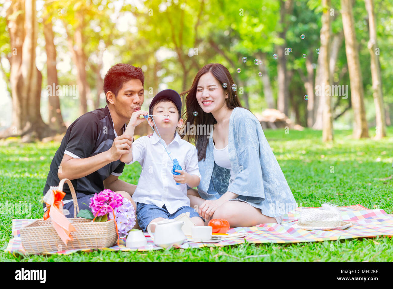 Asian teen family happy holiday picnic moment in the park Stock Photo