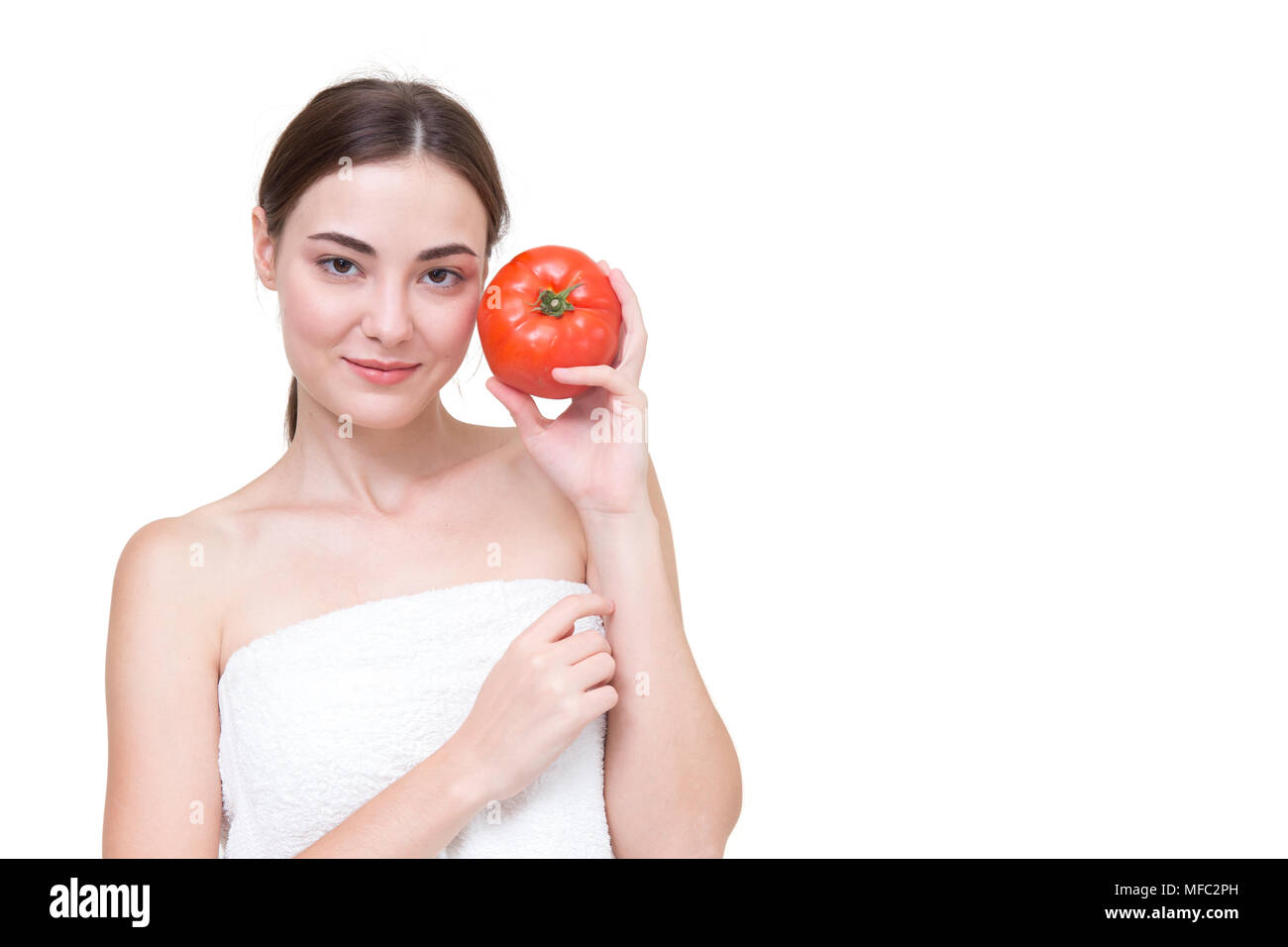 Beautiful women with tomato isolated on white Stock Photo