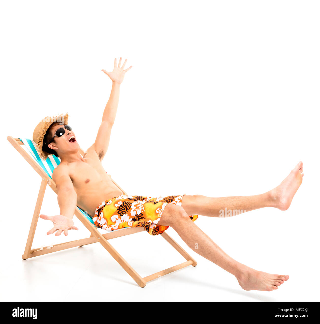 surprised and excited man sitting in lounger chair Stock Photo
