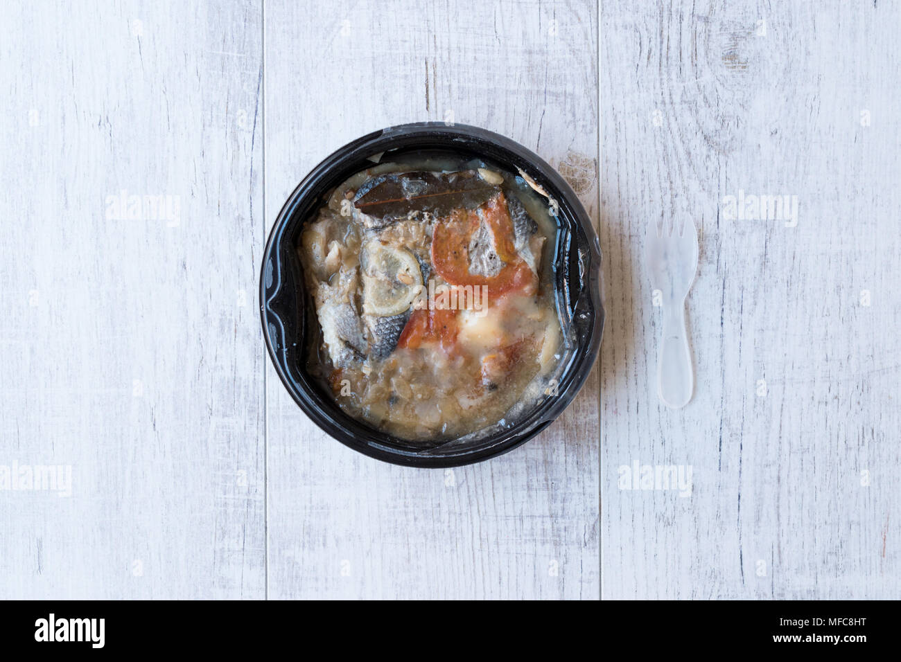 Instand Seafood Gilt-Head Sea Bream Fish in Plastic Container with Fork / Steamed Fish Stew. Organic Food. Stock Photo