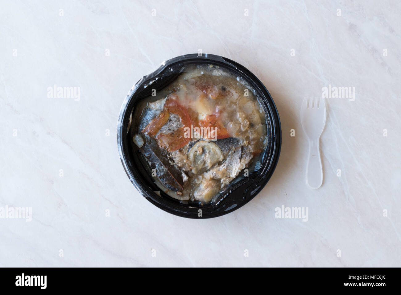 Instand Seafood Gilt-Head Sea Bream Fish in Plastic Container with Fork / Steamed Fish Stew. Organic Food. Stock Photo