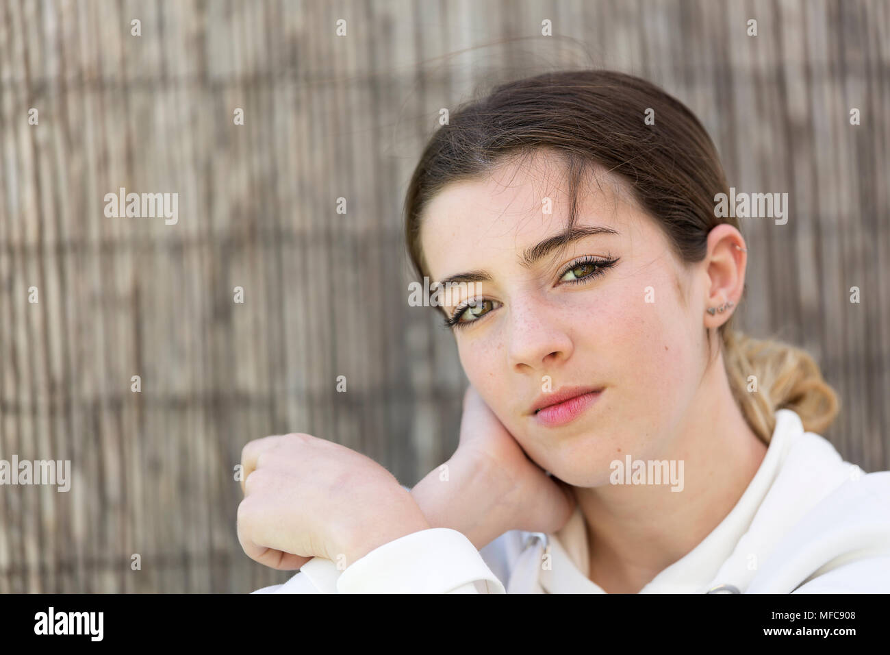 A teenager looking at camera to take some photos. Horizontal shot with natural light. Stock Photo