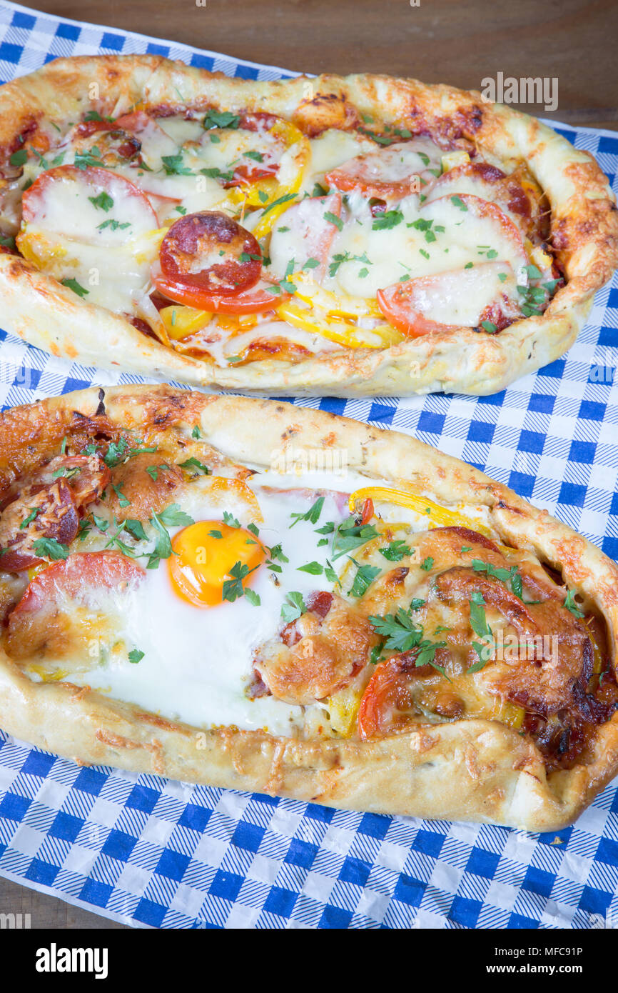 Handmade Turkish flat breads with cheese, tomato and egg. Yumurtali