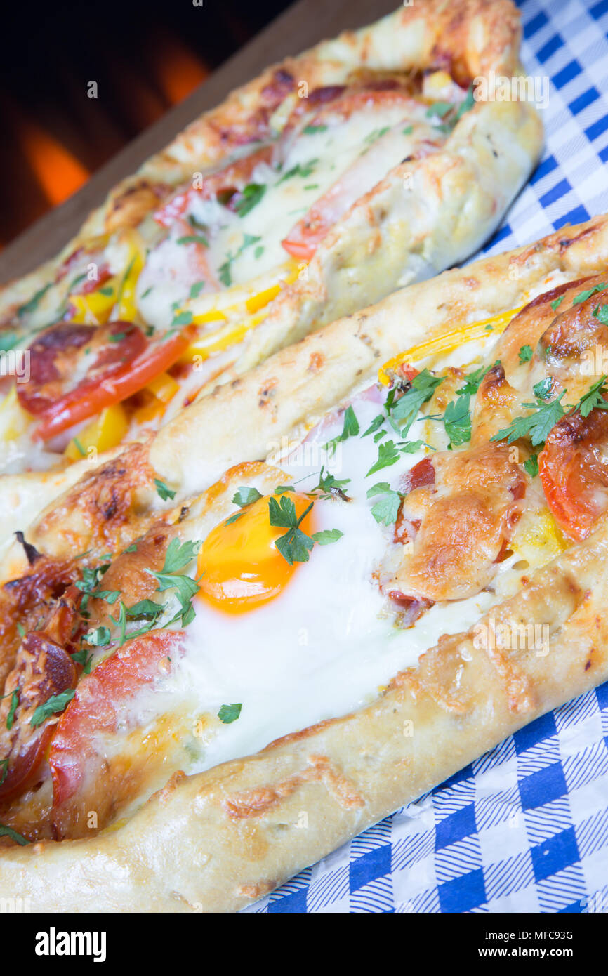Handmade Turkish flat breads with cheese, tomato and egg. Yumurtali