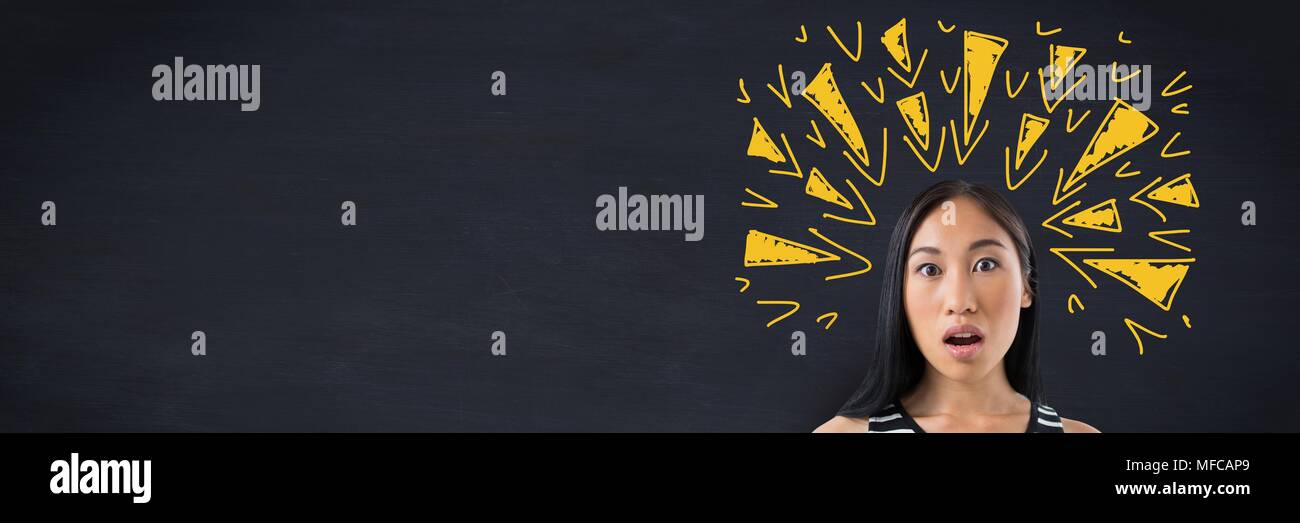 Shocked woman with tense doodles triangles on blackboard Stock Photo