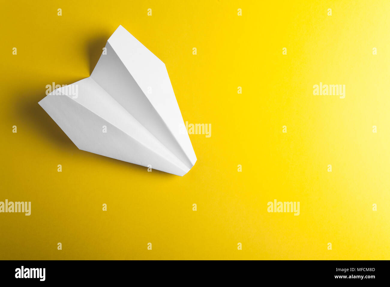 paper airplane on yellow background Stock Photo - Alamy
