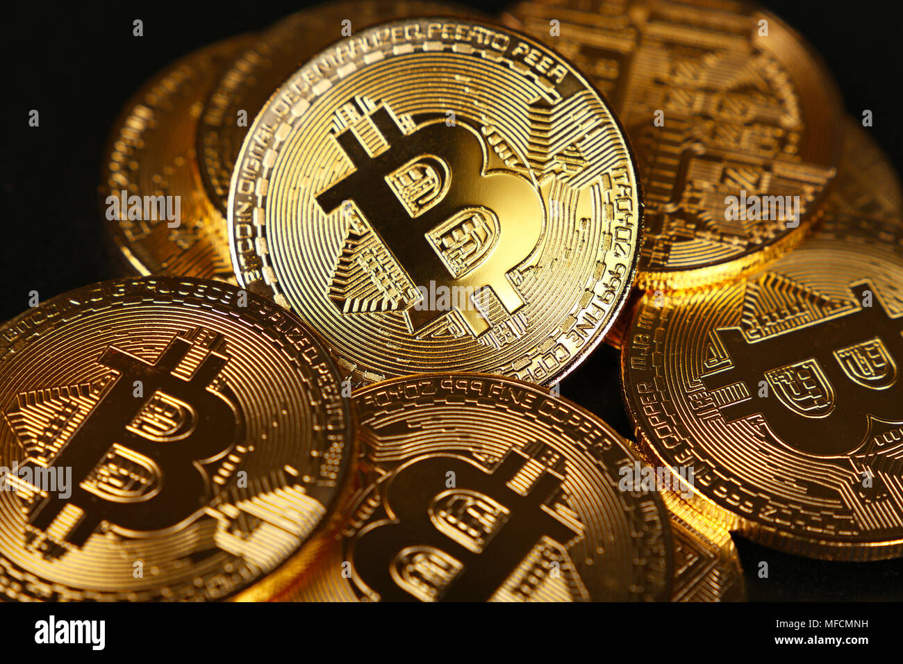 Close up heap of golden bitcoin physical coins over black background, high  angle view, selective focus Stock Photo - Alamy