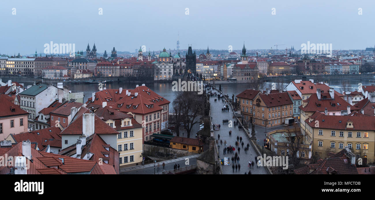High angle panorama of the famous Charles Bridge and the old town tower and churches in Prague, Czech Republic capital city at nightfall Stock Photo