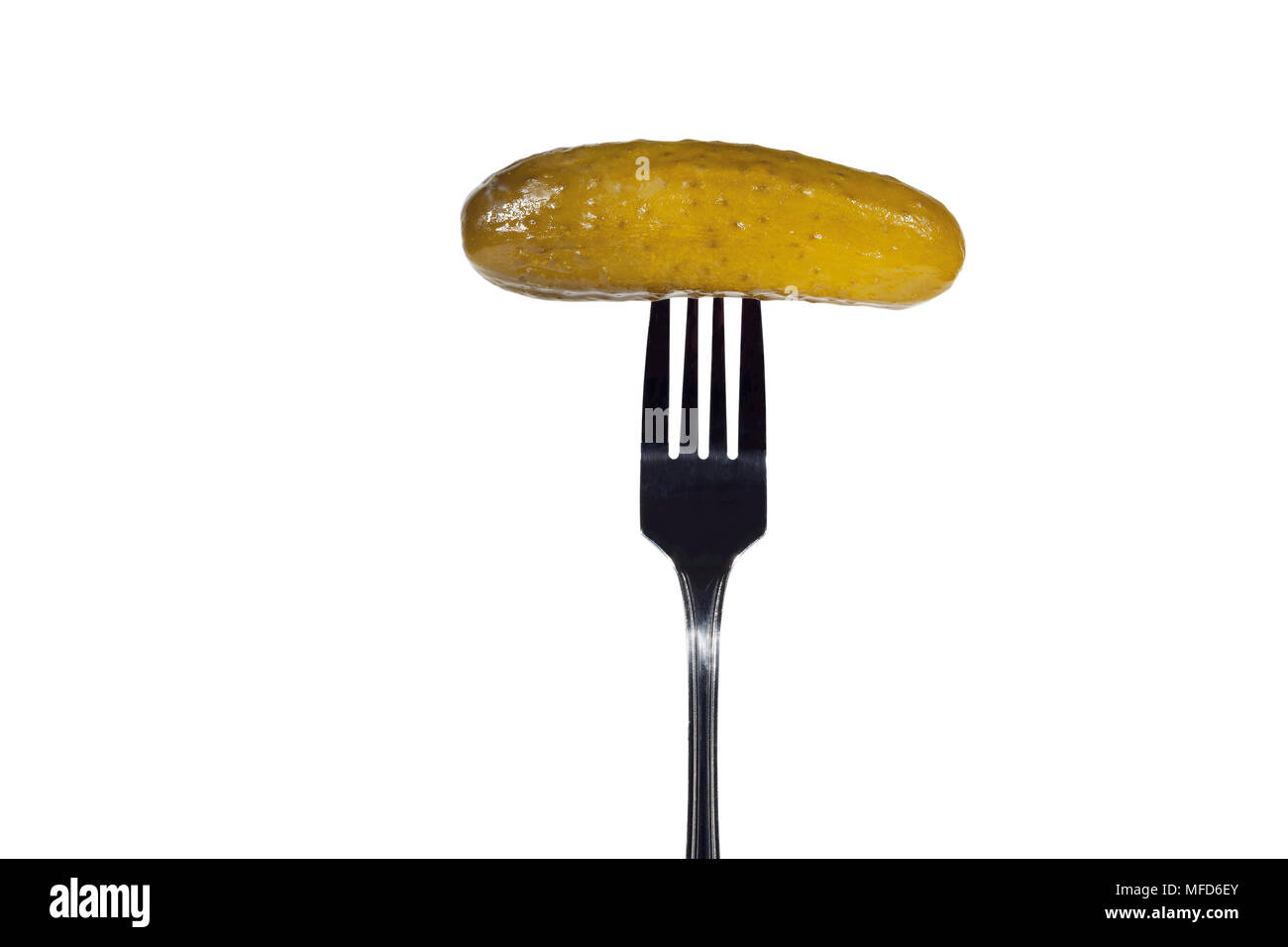 Salted cucumber on a fork. Isolated on white background. Stock Photo