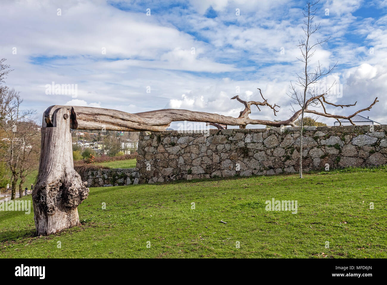 Vila Nova de Famalicao, Portugal - March 31, 2018: Urban art made of a dead tree with a hinge in Parque da Devesa Urban Park. Stock Photo