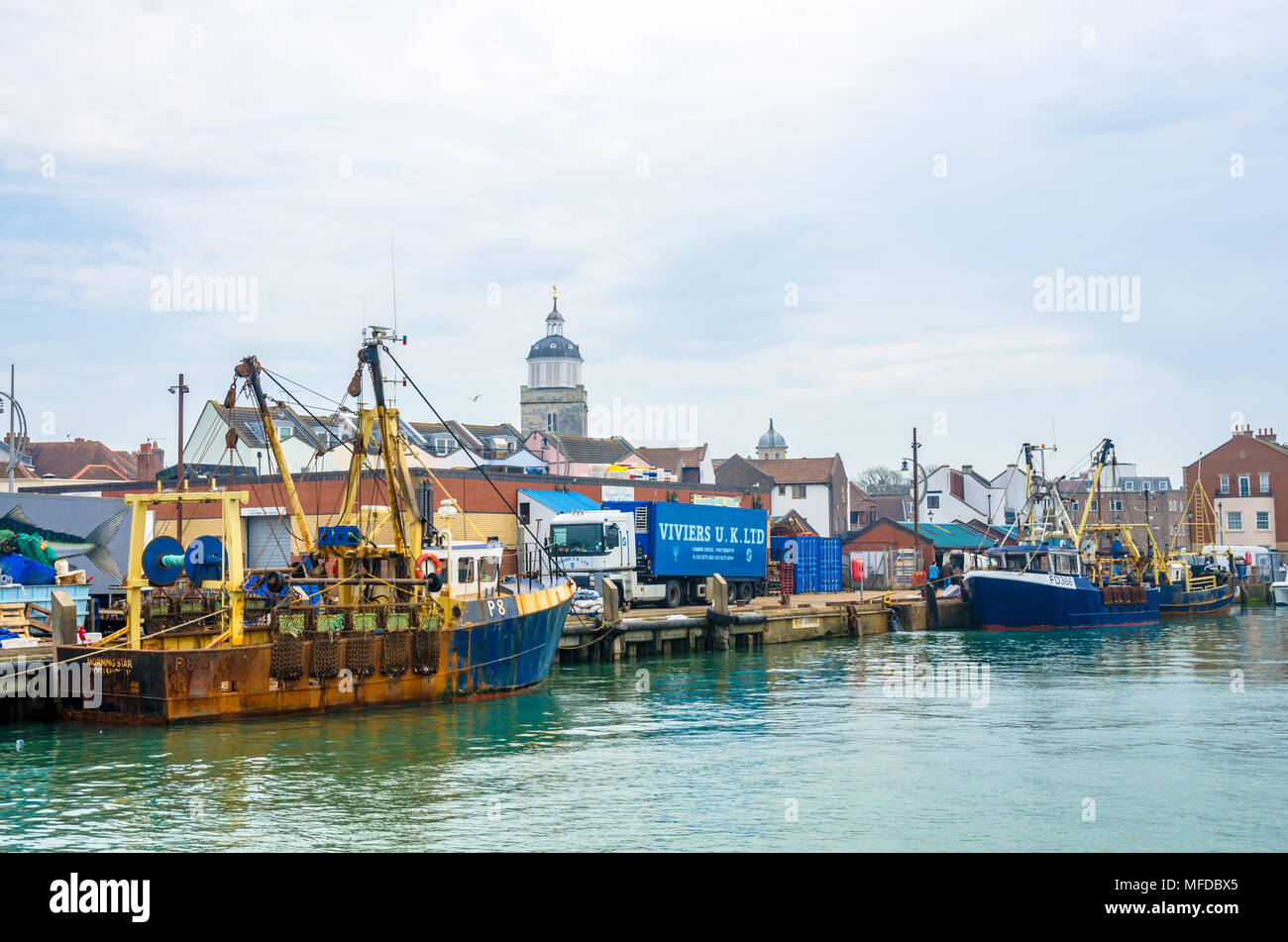 Fishing trawlers 'Morning Star' and 'Providing Star'  moored against the harbour wall in Portsmouth, UK. Stock Photo