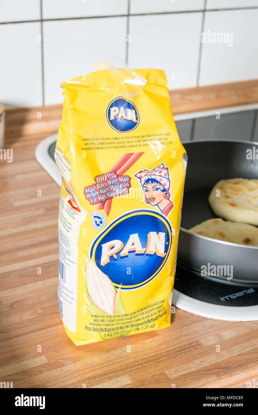 harina pan corn flour next to pan with arepa in it Stock Photo - Alamy