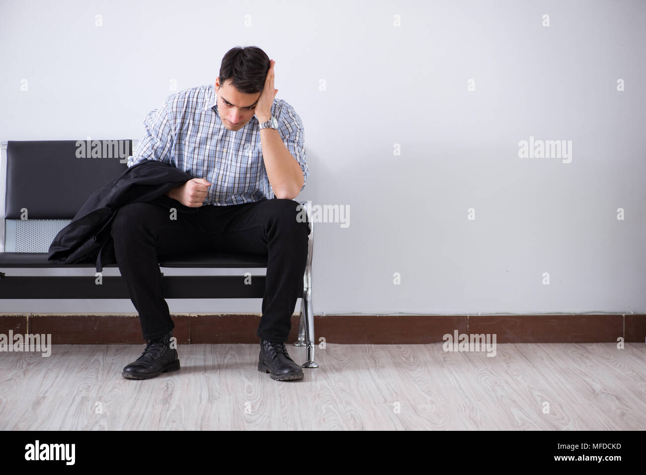 Waiting Intently Man nervously impatiently waiting in the lobby Stock Photo - Alamy