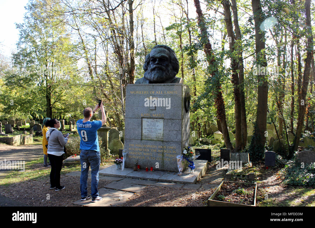 27 October 2017, Great Britain, London: Visitors photograph the grave of Karl Marx at Highgate cemetary in London. The bust was errected by the communist party of Great Britain in 1956. Photo: Christoph Driessen/dpa Stock Photo