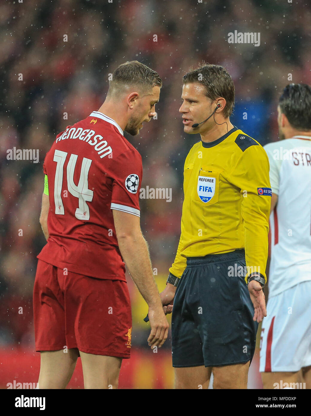 Liverpool, UK. 24th April, 2018. 24th April 2018 , Anfield, Liverpool, England; UAFA Champions League Semi Final, first leg, Liverpool v Roma ; referee Felix Brych talks to Jordan Henderson of Liverpool about Alex Oxlade-Chamberlain of Liverpool's injury Credit: News Images /Alamy Live News Stock Photo