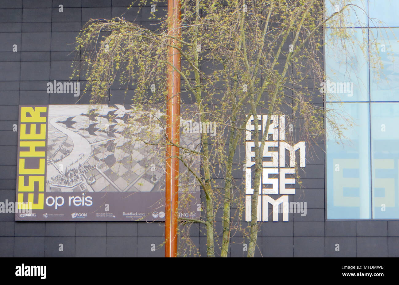 24 April 2018, Netherlands, Leeuwarden: The offical placard of the exhibition 'Escher on the road' in the Frisian museum. The cryptic, mostly black and white works from M.C. Escher are popular motives for t-shirts and maths books. The exhibition is running from the 28 April to the 28 October 2018. Photo: Annette Birschel/dpa Stock Photo