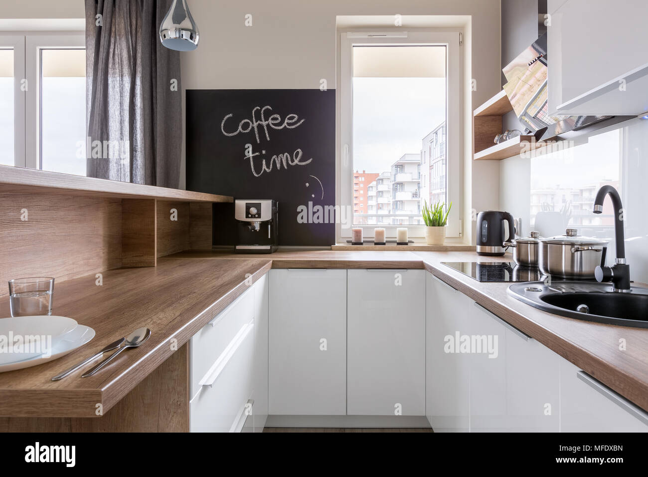 Kitchen With Wooden Countertop White Cabinets And Chalkboard