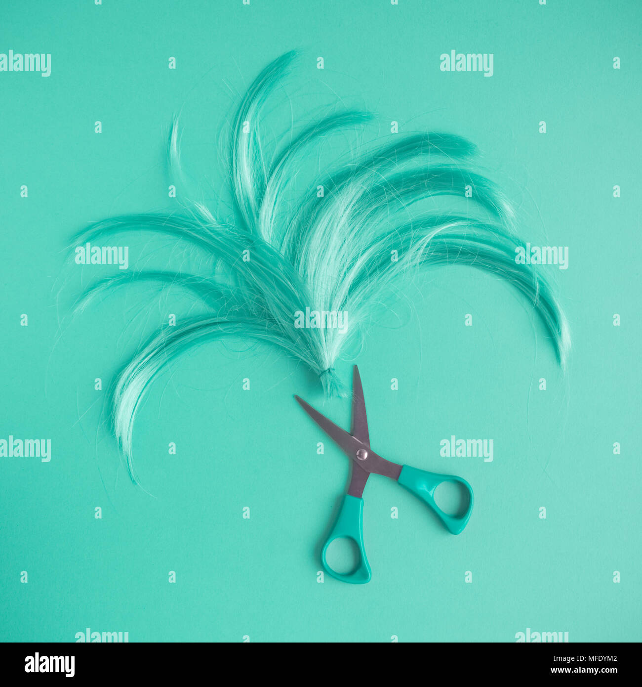 Wig and scissors turquoise tone hairstyle background. Stock Photo