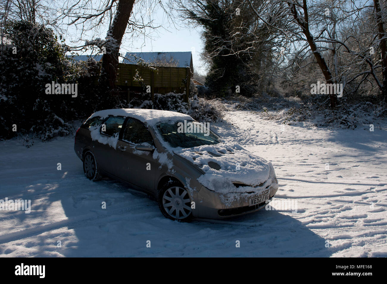 Nissan Primera car in a snow covered carpark in Tonbridge, Kent, UK Stock Photo