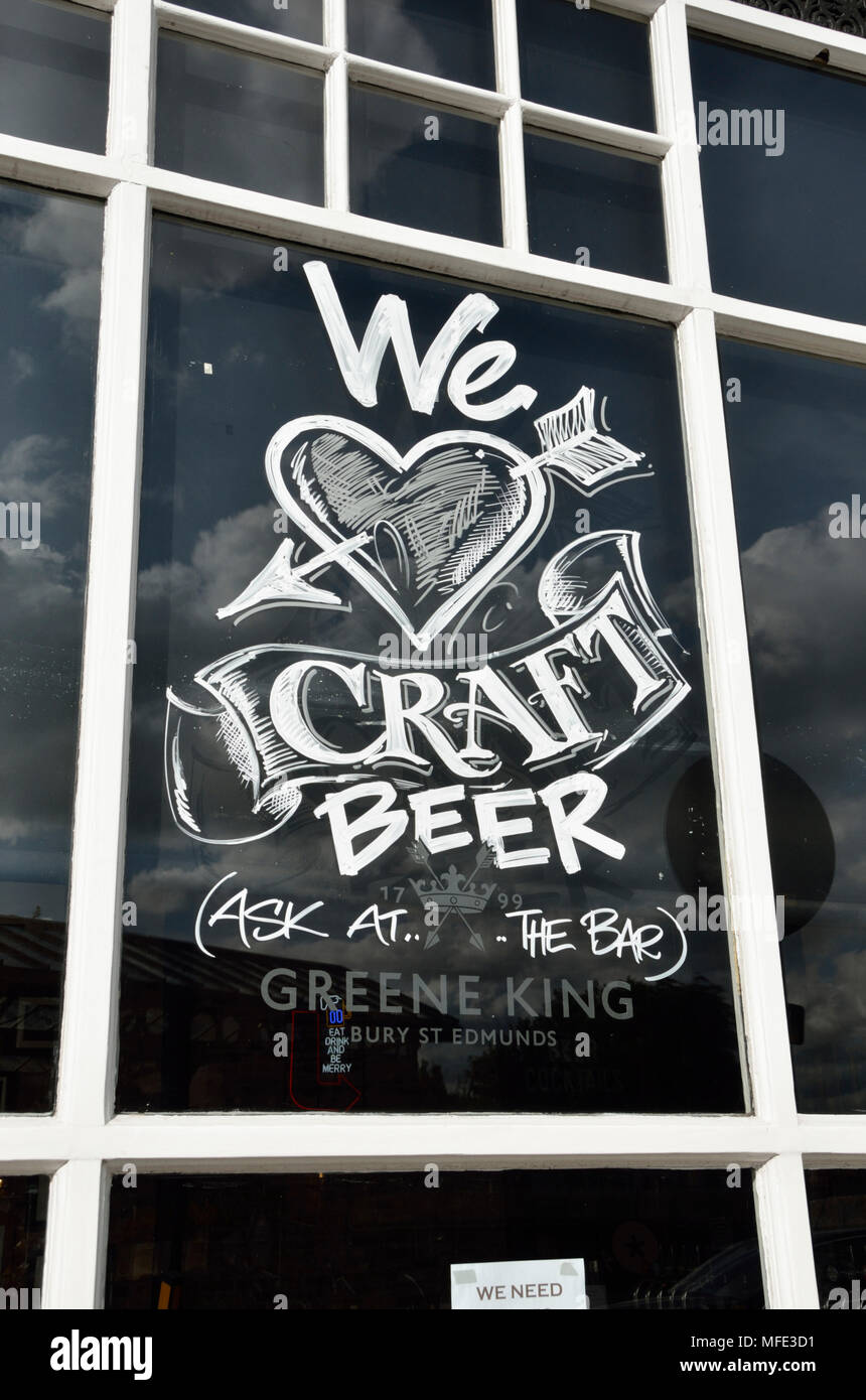 ’We love craft beer’ painted on a pub window Stock Photo